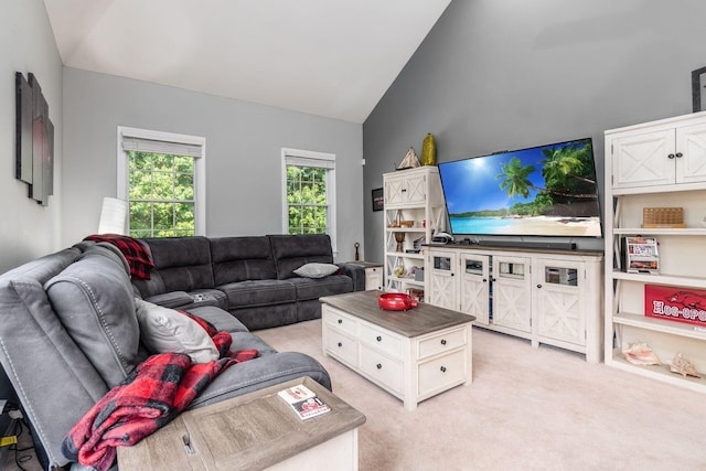 carpeted living room featuring high vaulted ceiling