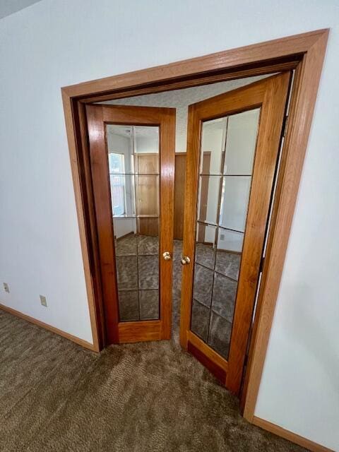 hallway with carpet flooring and french doors