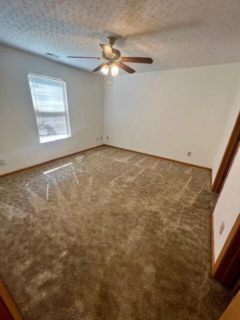 unfurnished room with ceiling fan, carpet flooring, and a textured ceiling