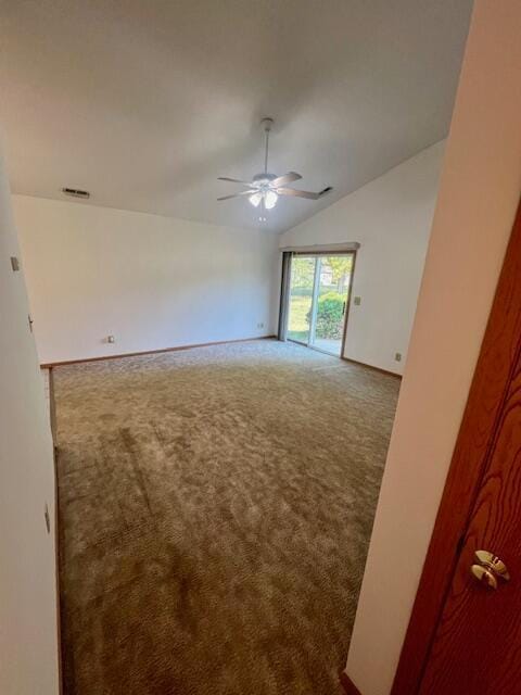 carpeted empty room with ceiling fan and vaulted ceiling