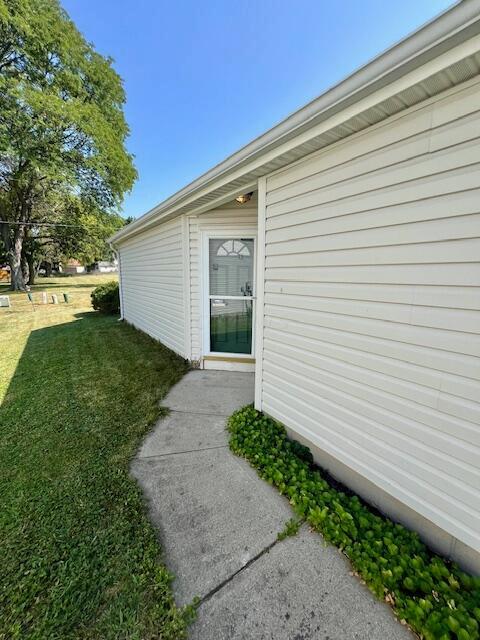 view of property exterior featuring a lawn