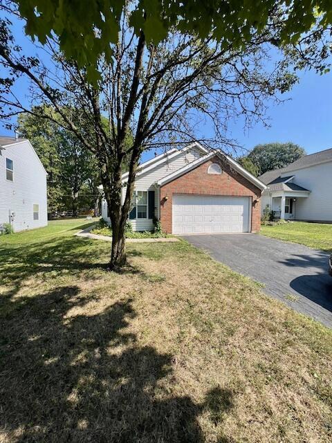 view of front of home with a garage and a front lawn