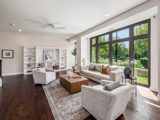 living room with dark hardwood / wood-style flooring and ceiling fan