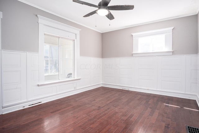 empty room featuring dark hardwood / wood-style floors, ceiling fan, and crown molding