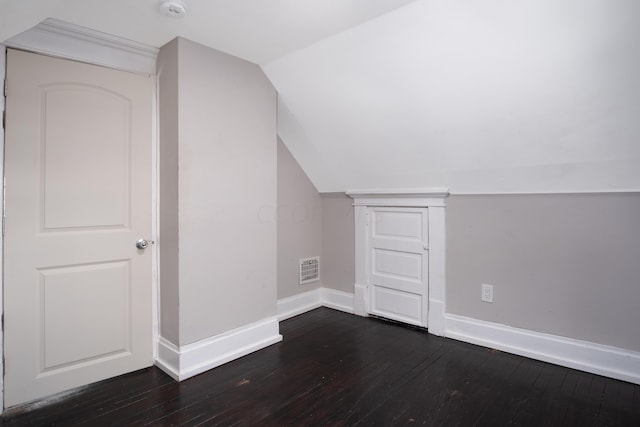 bonus room featuring dark wood-type flooring and vaulted ceiling