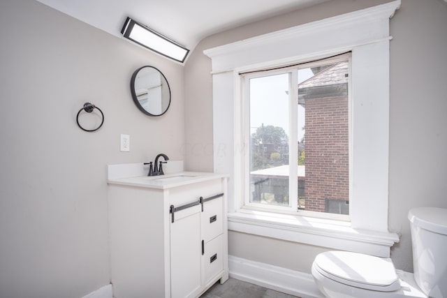 bathroom with tile patterned flooring, vanity, and toilet