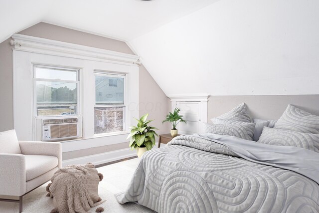 bedroom with cooling unit and lofted ceiling