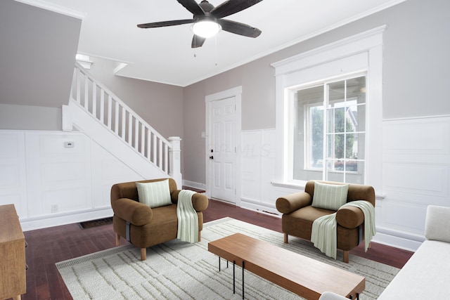 living room featuring ceiling fan, dark hardwood / wood-style floors, and ornamental molding