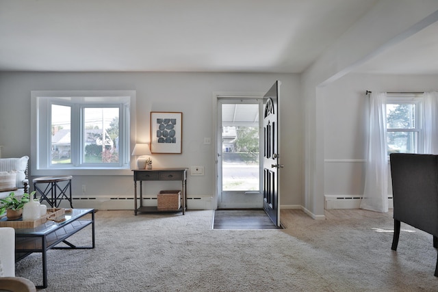 living area featuring carpet floors and a baseboard heating unit