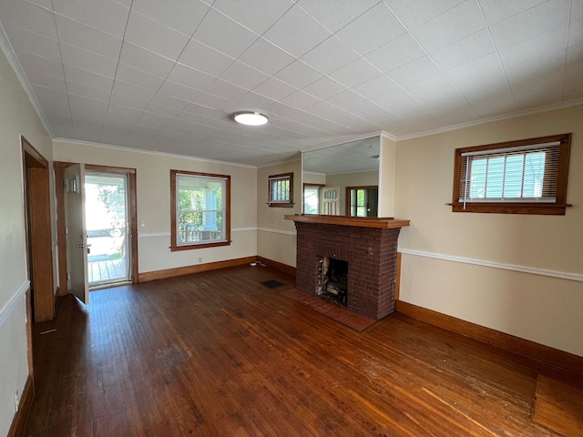 unfurnished living room with a fireplace, crown molding, and dark wood-type flooring