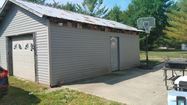 view of outdoor structure featuring a lawn and a garage