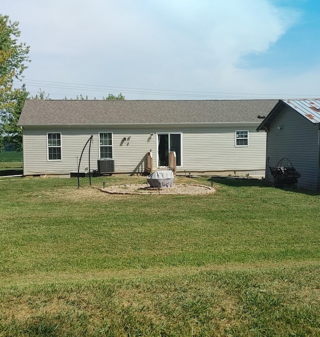 back of house with a yard and cooling unit