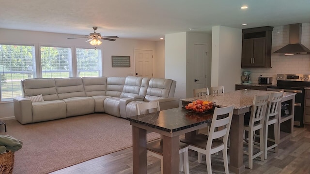 dining space with hardwood / wood-style flooring, ceiling fan, and a wealth of natural light