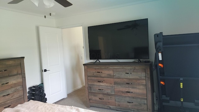 carpeted bedroom with ceiling fan and crown molding