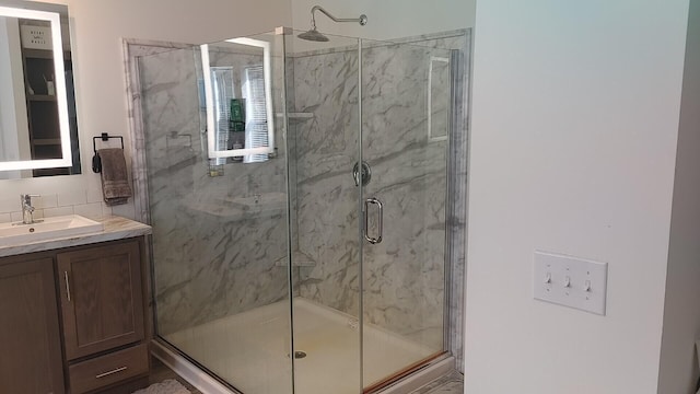 bathroom featuring vanity and an enclosed shower