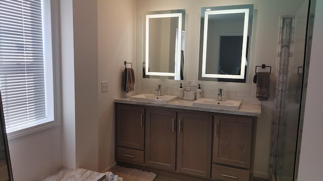 bathroom featuring vanity and a shower with shower door