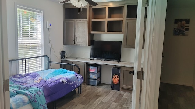 bedroom with ceiling fan and light hardwood / wood-style flooring