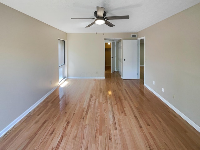 spare room featuring ceiling fan and light hardwood / wood-style floors