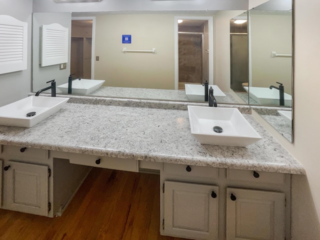 bathroom featuring vanity, wood-type flooring, and an enclosed shower