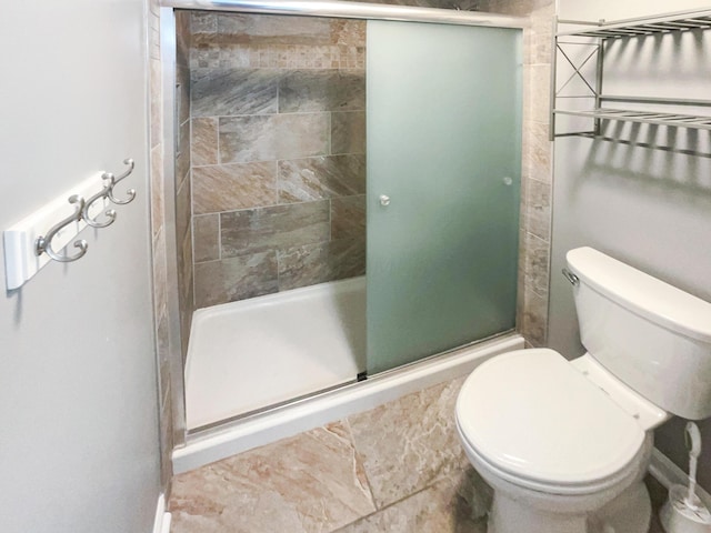 bathroom featuring an enclosed shower and toilet