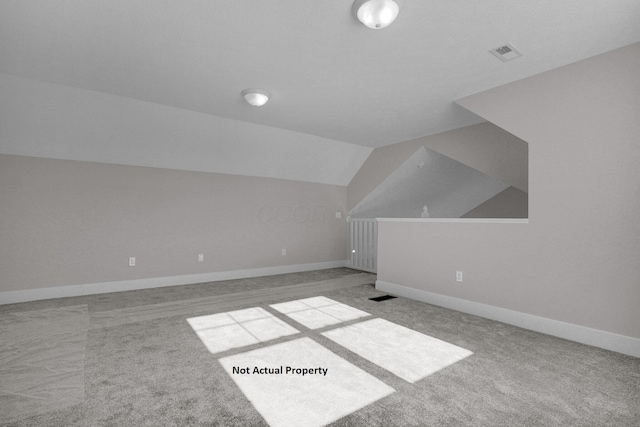 additional living space featuring light carpet and lofted ceiling