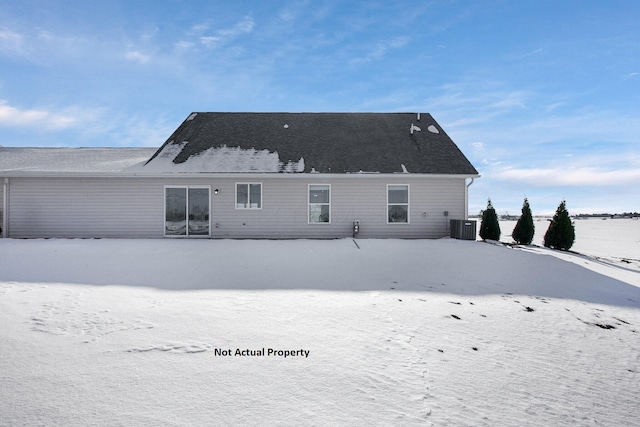 snow covered property featuring cooling unit