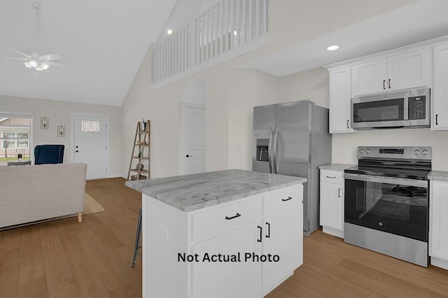 102 Cumberland Meadows Cir, Hebron, OH 43025 - kitchen featuring appliances with stainless steel finishes, open floor plan, ceiling fan, high vaulted ceiling, and light wood finished floors
