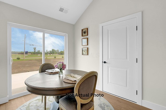 102 Cumberland Meadows Cir, Hebron, OH 43025 - dining space with vaulted ceiling, light wood-style floors, and view of golf course