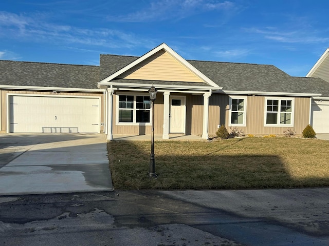 single story home featuring a front lawn and a garage