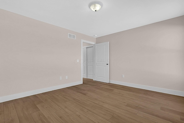 unfurnished room featuring hardwood / wood-style flooring