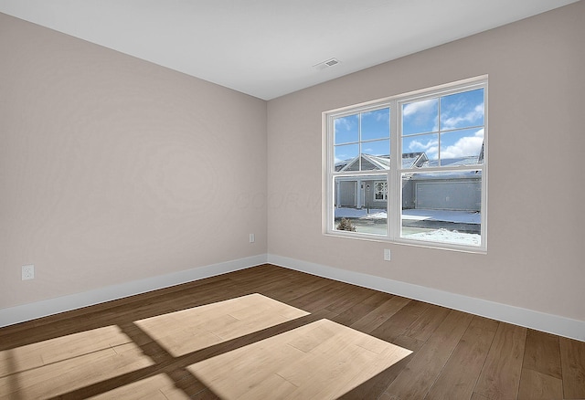 unfurnished room with dark hardwood / wood-style floors