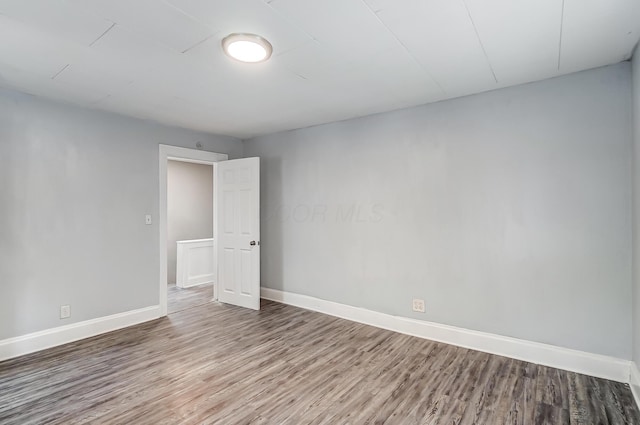 spare room featuring wood-type flooring