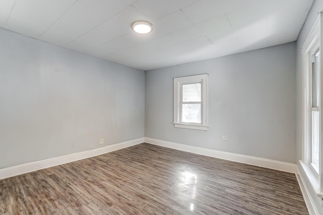 spare room featuring dark wood-type flooring