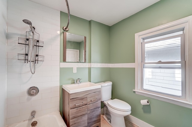 full bathroom with vanity, toilet, and tiled shower / bath