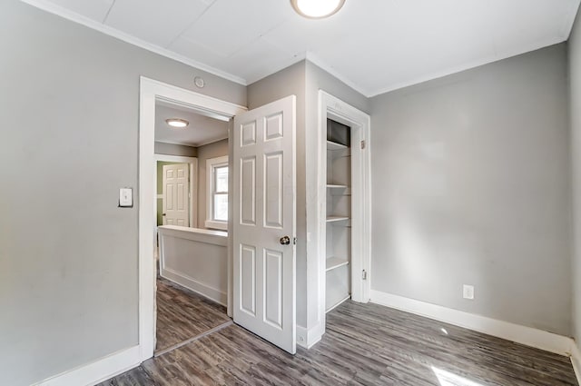 interior space with dark hardwood / wood-style floors and ornamental molding