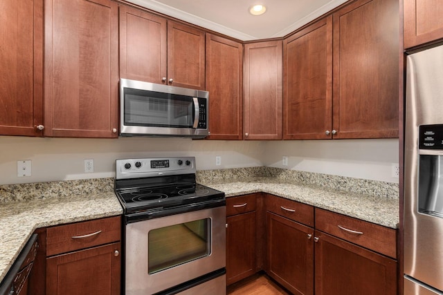 kitchen with light stone counters and appliances with stainless steel finishes