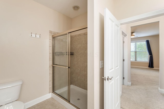 bathroom with toilet and a shower with shower door