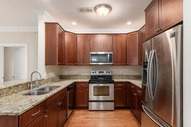 kitchen with light stone countertops, sink, stainless steel appliances, light hardwood / wood-style floors, and ornamental molding