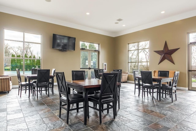 dining area featuring crown molding, french doors, and a healthy amount of sunlight