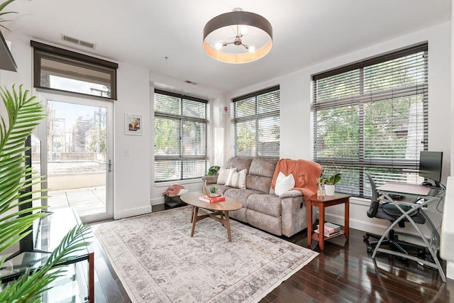 living room with ceiling fan and dark wood-type flooring