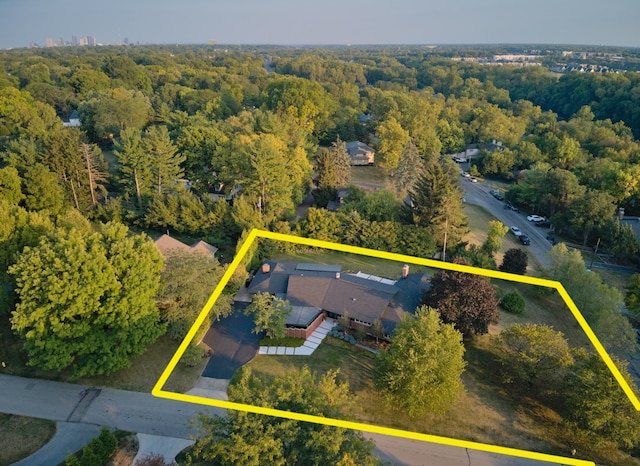 birds eye view of property with a view of trees