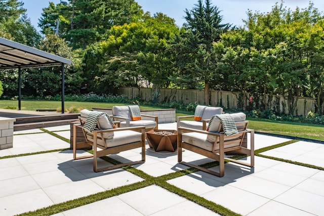 view of patio with an outdoor living space and fence