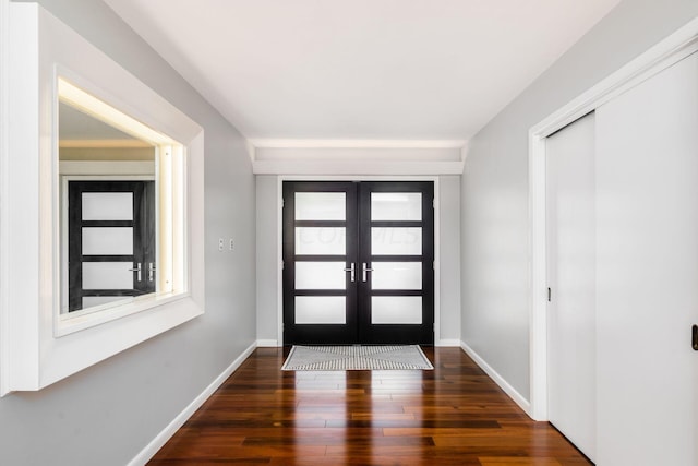 foyer with french doors, baseboards, and hardwood / wood-style floors