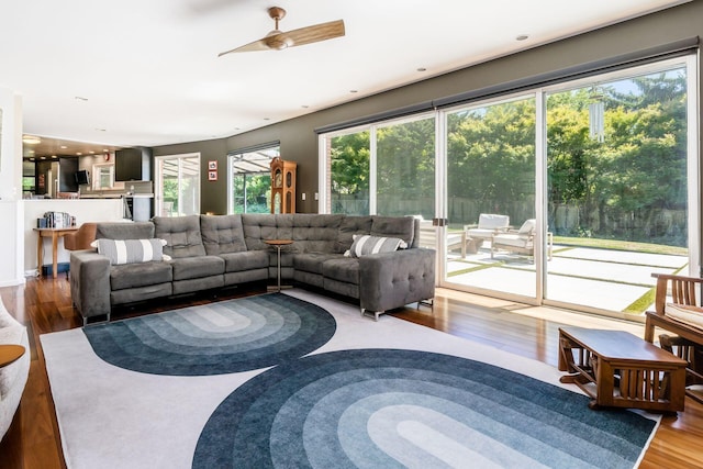 living area featuring a ceiling fan, recessed lighting, and wood finished floors