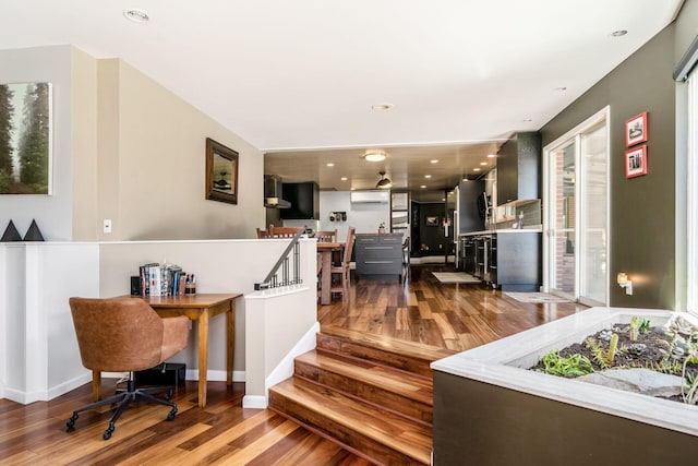 interior space with recessed lighting, wood finished floors, and a wall mounted AC