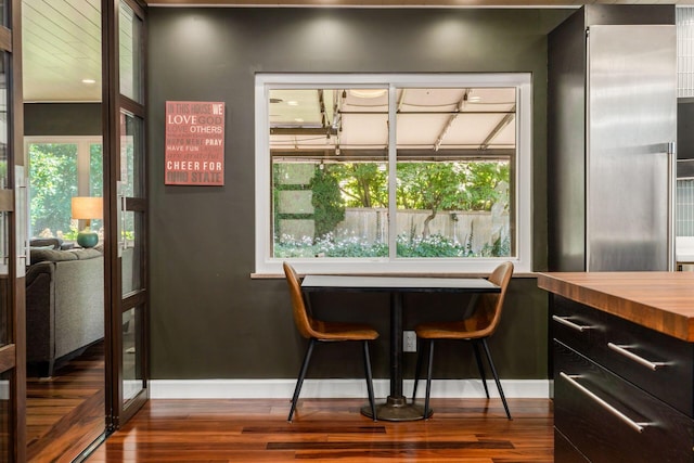 dining room with dark wood finished floors and baseboards