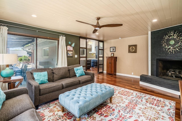 living room with wood finished floors, baseboards, a fireplace, recessed lighting, and wood ceiling