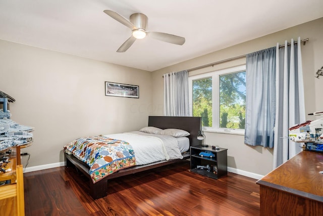 bedroom with ceiling fan, baseboards, and wood finished floors