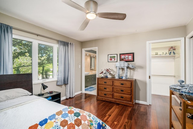 bedroom featuring connected bathroom, a ceiling fan, baseboards, and hardwood / wood-style flooring