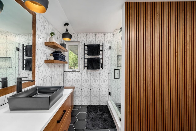 full bathroom featuring vanity, a shower stall, tile walls, and tile patterned floors